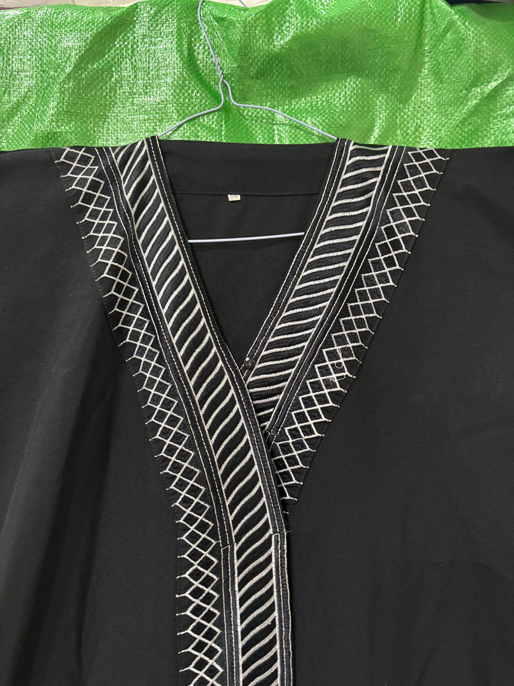 represent Black Traditional Thobe with White Geometric Woven