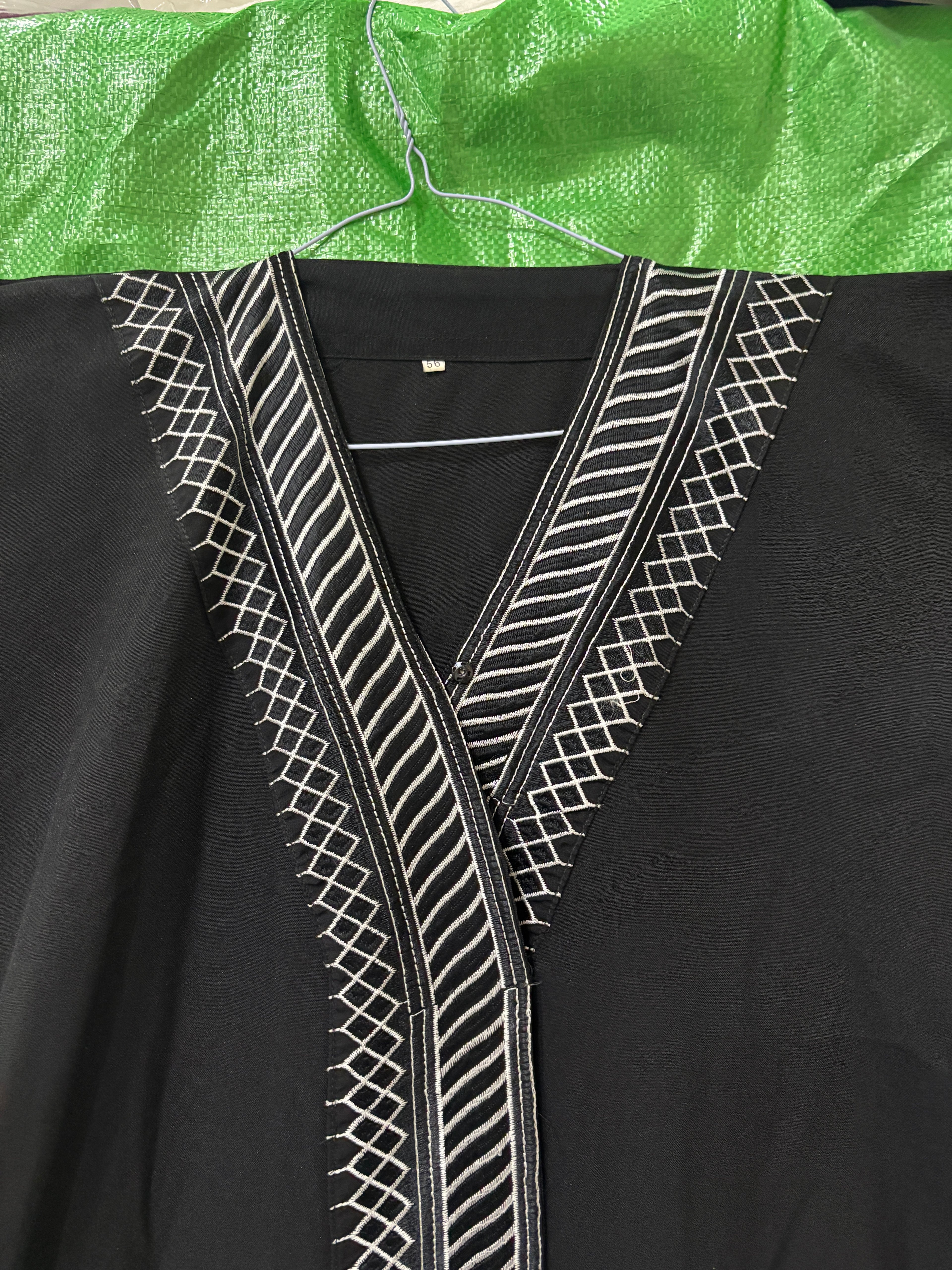 represent Black Traditional Thobe with White Geometric Woven