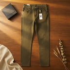 [WearU Generated:merch_flat_lay] Olive Green Cotton Denim Tapered Jeans – flat lay view